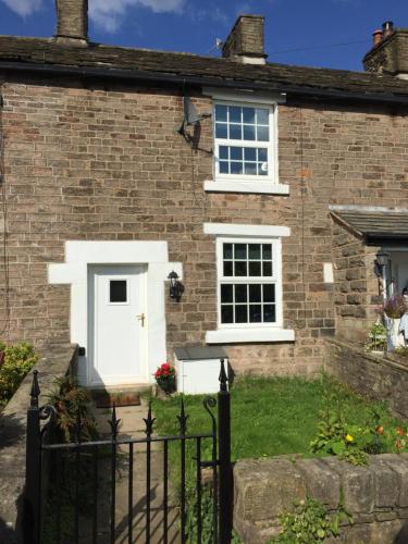 a brick house with a white door at Country Retreat in Highpeak Junction