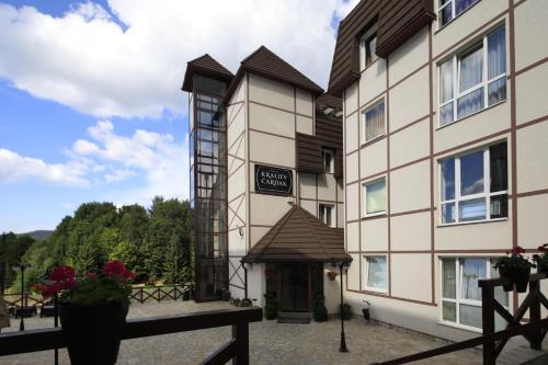 a building with a sign that says hotel at Apartment Planinska Carolija in Kopaonik