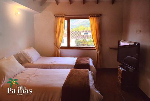 Säng eller sängar i ett rum på Hotel Villa Palmas