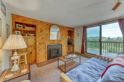 a living room with a couch and a fireplace at Snowside 22 in Waitsfield