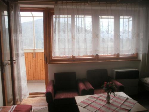 a living room with a table and chairs and a window at Vysoké Tatry - Svit in Svit