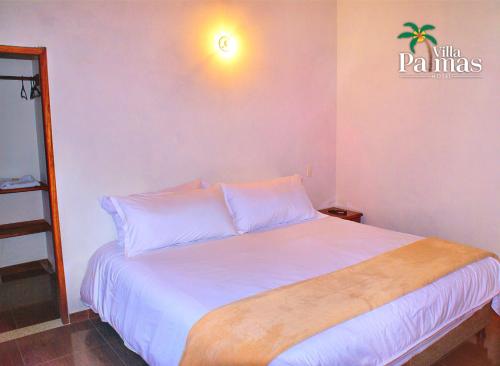 Katil atau katil-katil dalam bilik di Hotel Villa Palmas