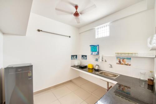 a kitchen with a sink and a counter at La Maison Charu in Puducherry