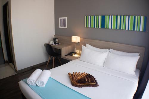 una camera d'albergo con un letto e un guanto sopra di Singgah Kertih a Kertih