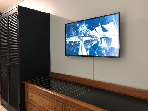 a flat screen tv on a wall in a room at Matador Motor Inn in Coffs Harbour
