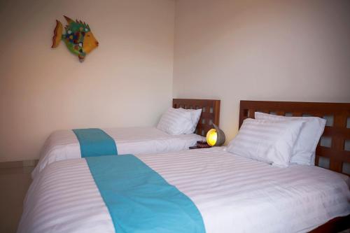 Ένα ή περισσότερα κρεβάτια σε δωμάτιο στο Pineapple Villa Sanur