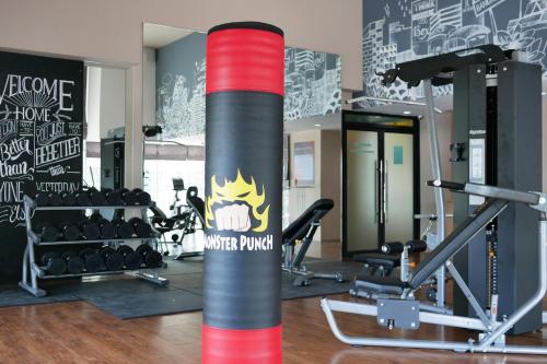 a gym with a red and gray pole and weights at The Riche Boutique Hotel Don Mueang Airport in Bangkok