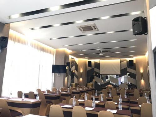 a restaurant with tables and chairs in a room at The Riche Boutique Hotel Don Mueang Airport in Bangkok