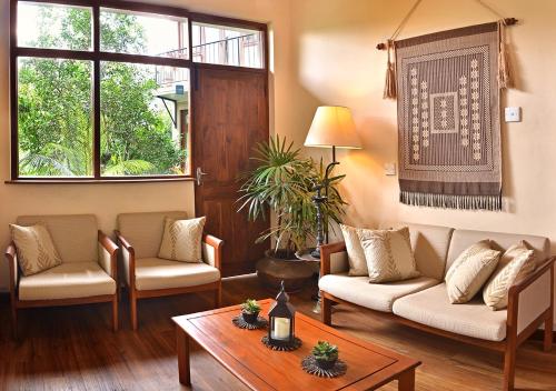 a living room with two couches and a table at Villa 49 in Kandy