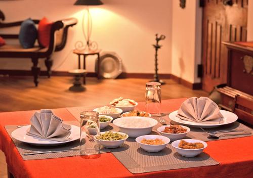 a table with bowls and plates of food on it at Villa 49 in Kandy