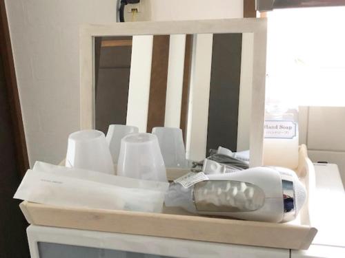 a pile of toothbrushes and cups on a table at Rapport Kukomae 207 in Fukuoka