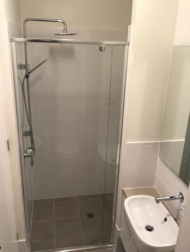 a shower in a bathroom with a toilet and a sink at Broughton Views in Corlette