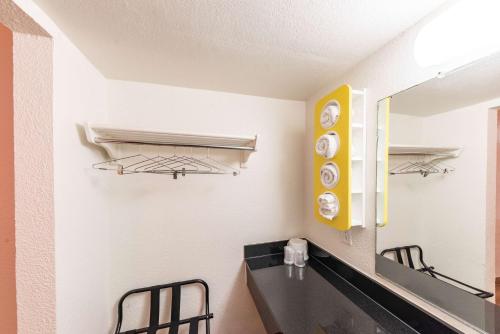 a kitchen with a sink and a mirror at Motel 6-North Richland Hills, TX in North Richland Hills