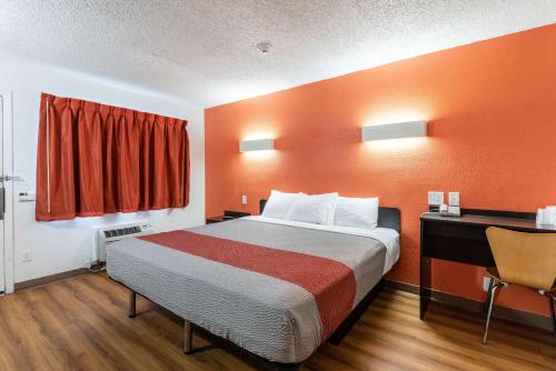 a hotel room with a bed and a desk at Motel 6-North Richland Hills, TX in North Richland Hills