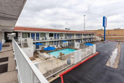 a view of a hotel with a pool and a building at Motel 6-North Richland Hills, TX in North Richland Hills