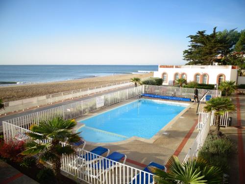 a large swimming pool next to a beach at Residence de L'Ocean in La Tranche-sur-Mer