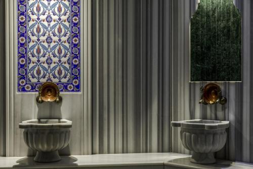 a bathroom with a sink and a painting on the wall at Hotel Venera Istanbul Old City in Istanbul