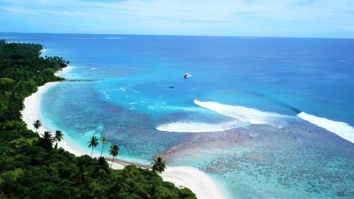 an aerial view of a beach with a boat in the water at Finimas Residence in Thimarafushi