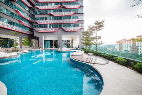 a swimming pool in front of a building at Arte Plus by Cobnb KLCC in Kuala Lumpur