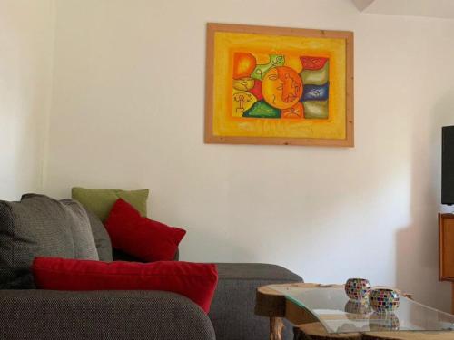 a living room with a couch and a painting on the wall at Gemütliche Ferienwohnung in ländlicher Idylle in Vöhl