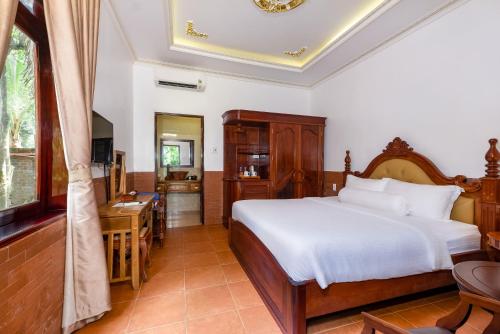 Postel nebo postele na pokoji v ubytování Coco Palm Beach Resort