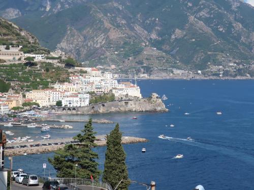 a view of a town on the side of a mountain at Turchese in Amalfi