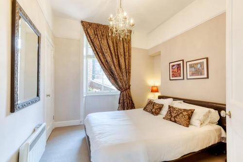 a bedroom with a bed and a window at West Port - 2BR in the heart of the old town just off the Grassmarket in Edinburgh