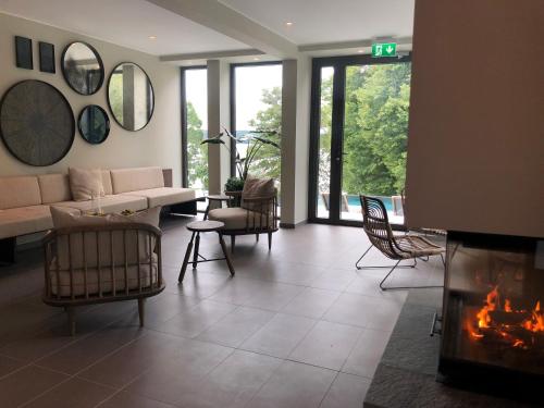 a living room with a couch and a fireplace at Villa Lovik in Lidingö