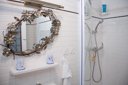 a bathroom with a shower and a mirror at Hier et Aujourd’hui 21 in Malakoff