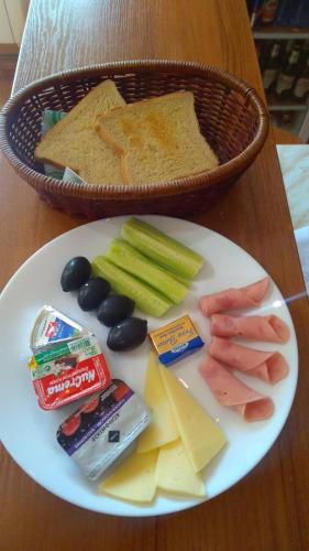 a plate of food with crackers cheese crackers and vegetables at Family Hotel Emaly 1 in Bankya