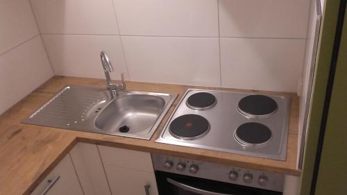 a kitchen counter with a sink next to a sink at Pension Freizeitzentrum Sambachshof in Bad Königshofen im Grabfeld