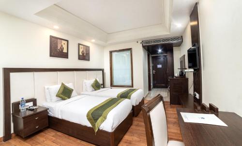 a bedroom with a bed and a table and a desk at Parkk Boutique Jodhpur - Mehrangarh Fort Road in Jodhpur