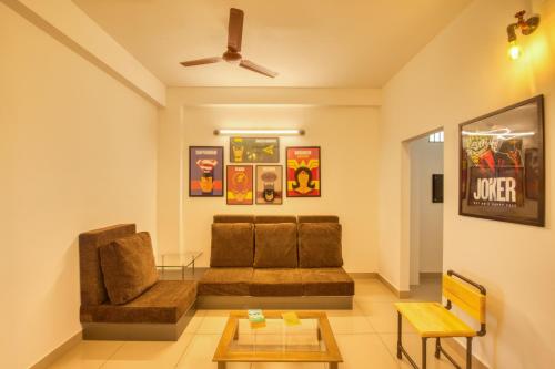 a living room with a couch and a table at La Maison Charu in Puducherry