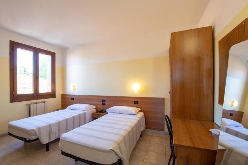 Een bed of bedden in een kamer bij Hotel Fattori