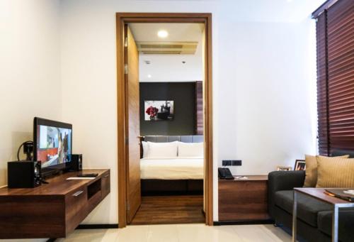 a hotel room with a bed and a mirror at LiT BANGKOK Residence - SHA Extra Plus in Bangkok