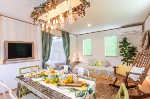 a living room with a table with fruit on it at Okinawa Seaside Besso5 in Onna