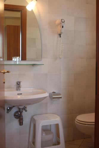 a bathroom with a sink and a toilet and a mirror at Hotel Lido in Vasto