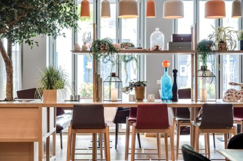 a large table with chairs and a blue bottle on it at Quality Hotel Residence in Sandnes