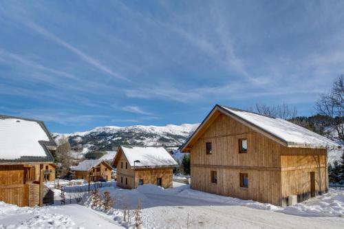 a group of wooden barns in the snow at Vacancéole - Les Gentianes in Gresse-en-Vercors