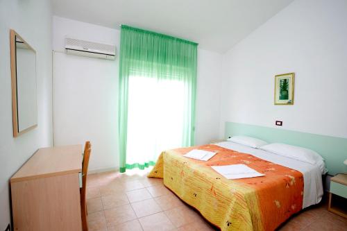 a bedroom with a bed and a large window at Long Beach Village Residence sul mare spiaggia privata inclusa in Lido Adriano