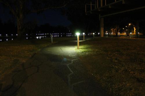 a light pole in the middle of a park at night at Forbes Victoria Inn in Forbes