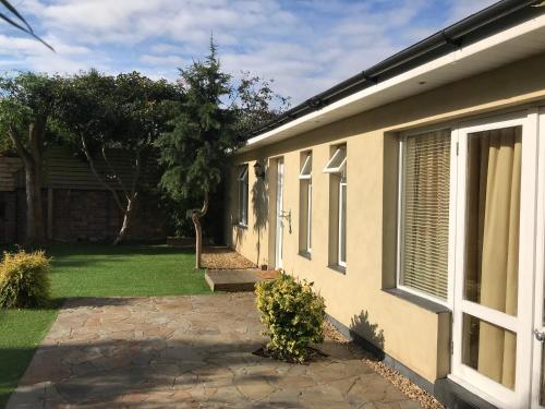 a side view of a house with a patio at The Coach House in Cardiff