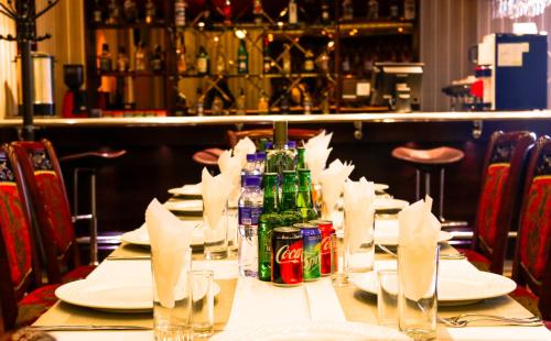 a table in a restaurant with plates and soda cans at Platinum Hotel Ulaanbaatar in Ulaanbaatar