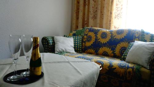 a bottle of champagne on a table next to a couch at Haus Bergkristall in Längenfeld