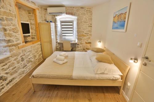 a bedroom with a large bed in a room at Split Inn Apartments in Split