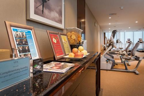 a hotel room with a counter with fruit and exercise equipment at City Of Dreams - Nüwa Manila in Manila