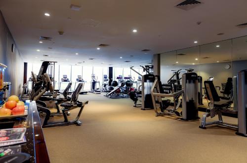 a gym with treadmills and cardio equipment in a building at City Of Dreams - Nüwa Manila in Manila