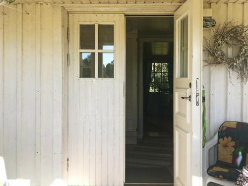 an open door to a house with a porch at 6 person holiday home in VARA in Skår