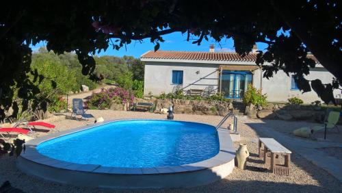 a swimming pool in front of a house at Ferienappartement Angelika in Arzachena