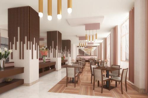 a restaurant with tables and chairs in a room at Ramada by Wyndham Van in Van